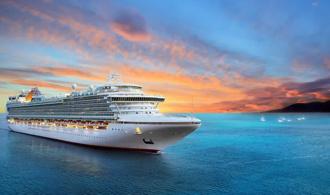Cruise ship offshore at sunset